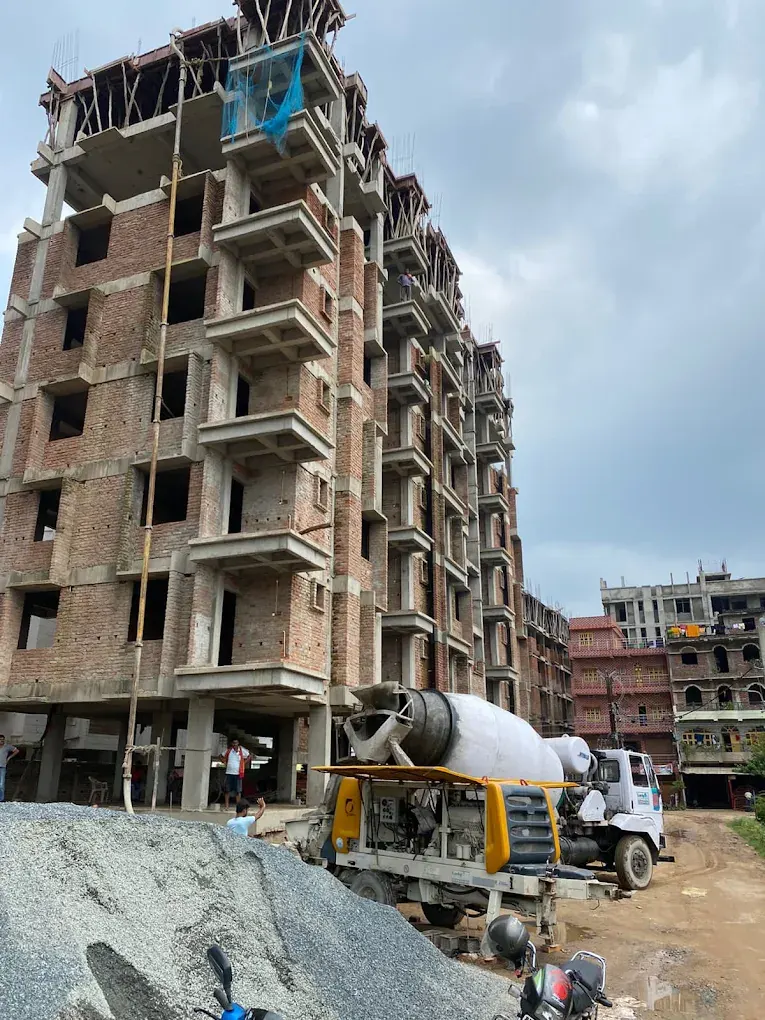 Multi-storey building under construction with concrete mixer